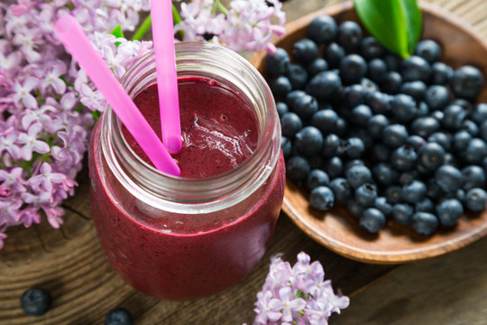 Blueberry smoothie and lilac flowers
