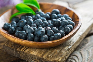 Fresh blueberries in a wooden plate