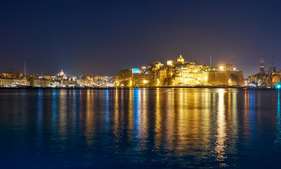 Fototapeta na wymiar The night view of Grand Harbour and Senglea peninsula, Malta