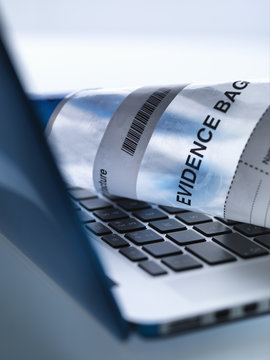 Laptop computer ready to take away in forensic evidence bag