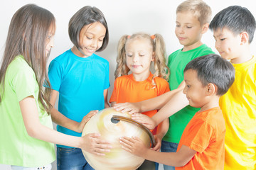 Group of international kids holding globe earth