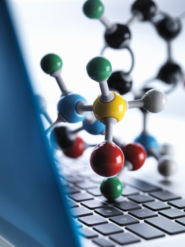 Close up of molecular model sitting on top of lap top computer keyboard to illustrate science education and computer aided research