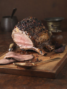 Christmas dinner. Bone in sirloin joint with peppercorn crust and brandy glaze served with roasted potatoes