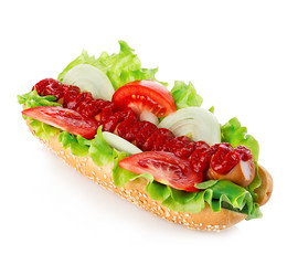 American style hot dog with lettuce, onion and tomato close-up on white background. Fast food.