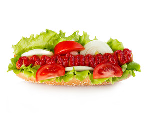 American style hot dog with lettuce, onion and tomato close-up on white background. Fast food.