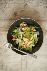 Overhead of Dining Fork on Bowl of Light Vegetable Salad