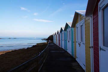 Beach huts at dawn by the beach at Bude, Cornwall