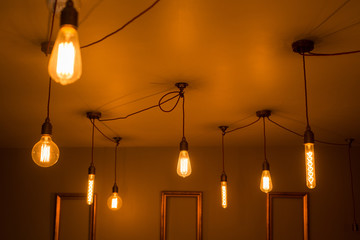 Fototapeta na wymiar A Collection of Illuminated Light Bulbs on a Ceiling