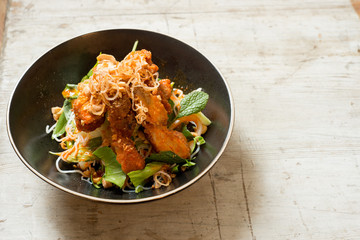 Salad Topped with Slice of Terrine in Black Round Bowl with Copy Space