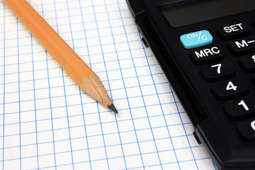 Calculator with pencil on notebook