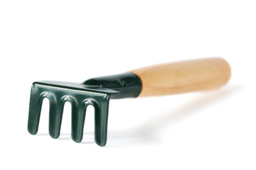 Garden tools - a rake on a white background