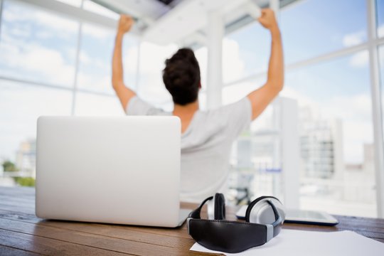 Man cheering at his desk