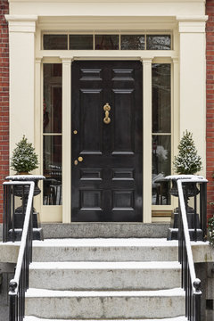 Front door with grand entrance way with black railings