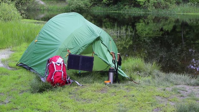 Camping in the woods on the banks of the river.