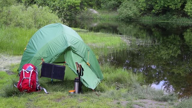 Camping in the woods on the banks of the river.