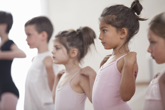 Row of children practicing in ballet school