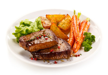 Grilled beef steaks and vegetables