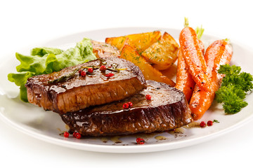 Grilled beef steaks and vegetables