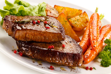 Grilled beef steaks and vegetables