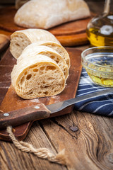 Sliced ciabatta bread on cutting board.