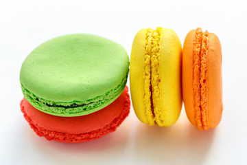 pile of colorful and tasty french macaroons on white background