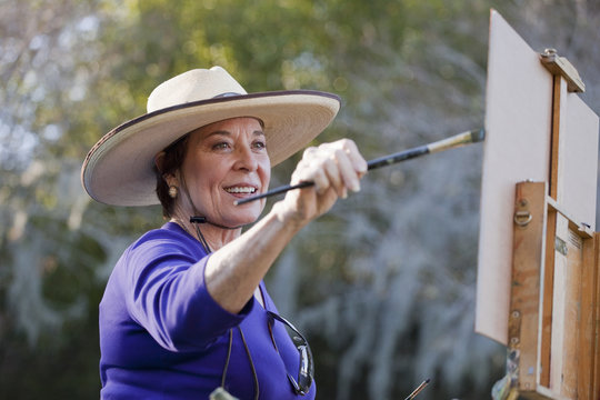 Female plein-air painter painting in Albin Polasek Museum and Sculpture Garden, Winter Park, Florida, USA