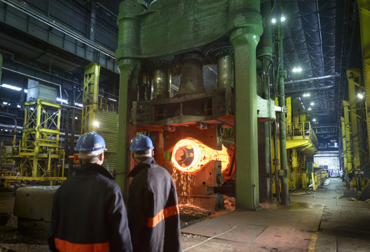 Steelworkers with 10,000 tonne forging press in steelworks