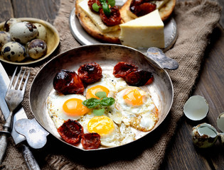 Fried quail eggs with tomato and basil