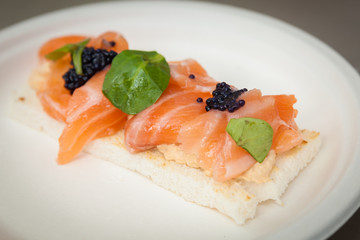toast appetizer of salmon and caviar