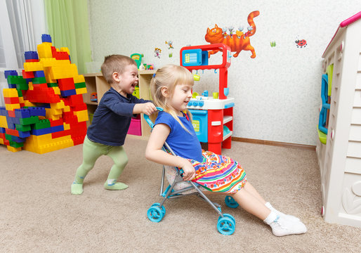 Children play with toy stroller in daycare