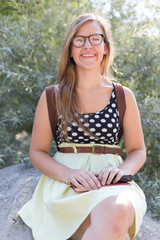 a beautiful young smiling woman with long fair hair is sitting o