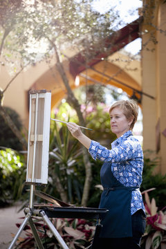 Female artist painting in Albin Polasek Museum and Sculpture Garden, Winter Park, Florida, USA