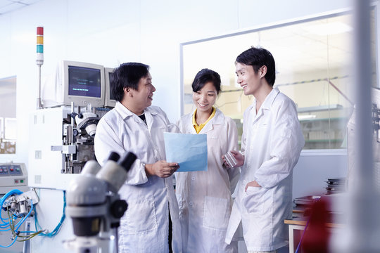 Technician discussing document in LED factory