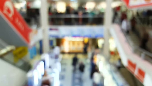 Shopping mall interior with customers, blurred background