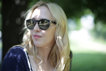 Naklejka premium Beautiful young blond woman outdoors portrait near the lake