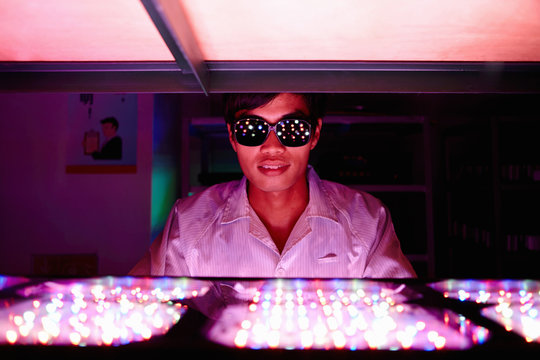 Technician wearing protective goggles in LED factory