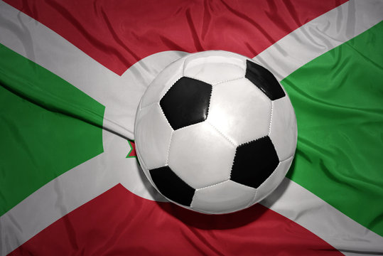 black and white football ball on the national flag of burundi