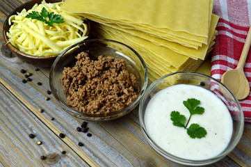 Lasagna ingredients on wooden table