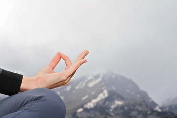 Yoga woman meditation on mountain peak, close up of hands