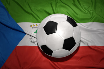 Naklejka premium black and white football ball on the national flag of equatorial guinea