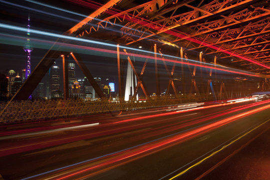 Cars travelling across bridge at night, long exposure, Shanghai, China