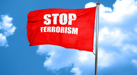 Red flag with stop terrorism waving against cloudy sky