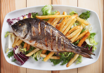 Grilled fish with salad and french fries