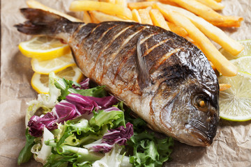 Grilled fish with salad and french fries