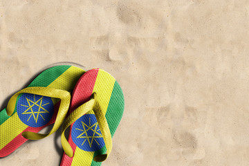 Thongs with flag of Ethiopia, on beach sand