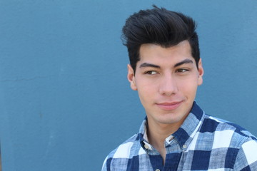 Young beautiful male thinking looking to the side at blank copy space, isolated over blue background