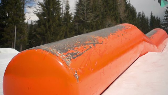 snowboard slow motion,snowboarder jumping on kink rail slow motion close up