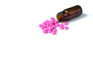 bottle of pills spilled out onto table