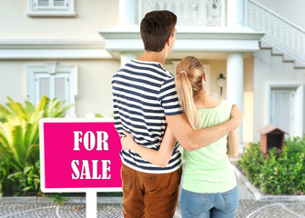 Loving couple looking at their dream house