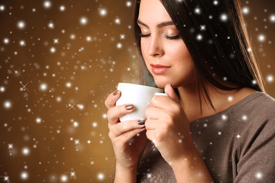 Pretty woman and cup of coffee with snow effect